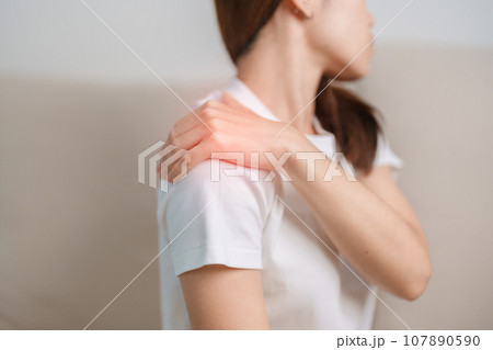 Woman having Shoulder and Neck pain during sitting on couch at home. Muscle painful due to Myofascial pain syndrome and Fibromyalgia, rheumatism, Scapular pain, Cervical Spine. ergonomic concept Woman having Shoulder and Neck pain during sitting on couch at home. Muscle painful due to Myofascial pain syndrome and Fibromyalgia, rheumatism, Scapular pain, Cervical Spine. ergonomic concept 107890590