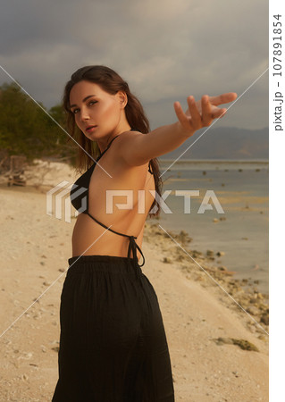 sexy girl on the beach. young beautiful woman next to sea 107891854