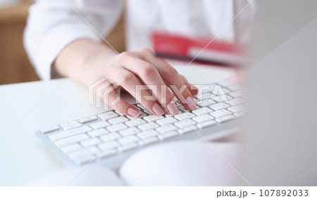 Female hands hold credit card pressing Female hands hold credit card pressing 107892033