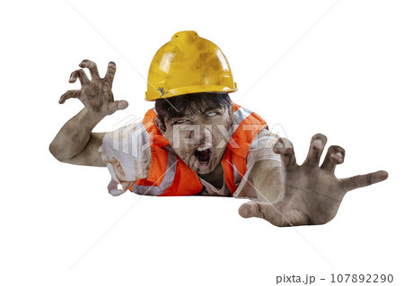 A scary construction worker zombie with blood and wounds on his body crawling A scary construction worker zombie with blood and wounds on his body crawling 107892290
