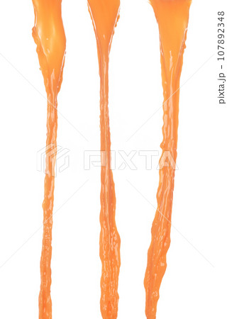 Orange Juice pouring down in Shape form line. Orange juicy fluttering explosion in air, liquid water splash spill like explosion droplet. White background isolated, stop motion freeze shot. 107892348