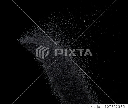 Million of black sand explosion, Photo image of falling down sands flying. Freeze shot on black background isolated overlay. Tiny Fine sand dust magnet as particle disintegrate science 107892376