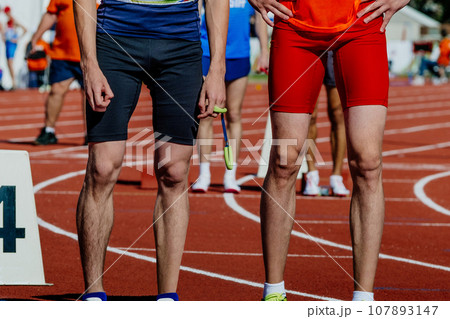 blind para athlete runner with guide in starting line sprint race, in hand tether wrist, summer para athletics championships blind para athlete runner with guide in starting line sprint race, in hand tether wrist, summer para athletics championships 107893147