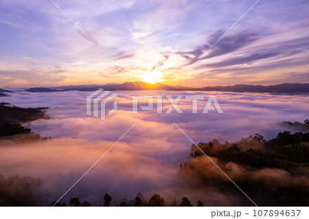 Amazing Sunrise or sunset over mountains hills covered with mist, Aerial view landscape drone shot beautiful colorful nature background 107894637