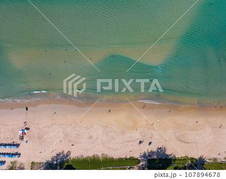 Summer sea nature background,Aerial view of Waves crashing on sandy shore,Sea surface ocean waves background,Top view beach background 107894678
