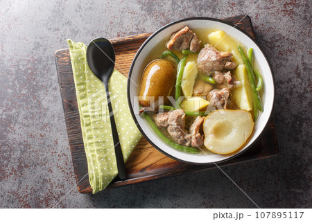 Swedish Lamb stew with fresh pears, potatoes, green beans close-up in a bowl. horizontal top view 107895117