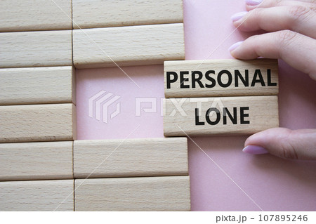 Personal Loan symbol. Concept word Personal Loan on wooden blocks. Businessman hand. Beautiful pink background. Business and Personal Loan concept. Copy space Personal Loan symbol. Concept word Personal Loan on wooden blocks. Businessman hand. Beautiful pink background. Business and Personal Loan concept. Copy space 107895246