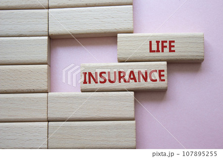 Life insurance symbol. Concept word Life insurance on wooden blocks. Beautiful pink background. Business and Life insurance concept. Copy space 107895255