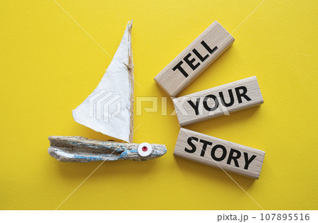 Tell your story symbol. Wooden blocks with words Tell your story. Beautiful yellow background with boat. Business and Tell your story concept. Copy space. Tell your story symbol. Wooden blocks with words Tell your story. Beautiful yellow background with boat. Business and Tell your story concept. Copy space. 107895516