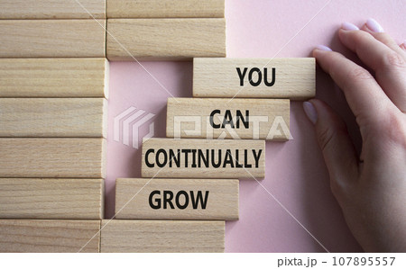 You can Continually Grow symbol. Wooden blocks with words You can Continually Grow. Businessman hand. Beautiful pink background. Business and You can Continually Grow concept. Copy space. You can Continually Grow symbol. Wooden blocks with words You can Continually Grow. Businessman hand. Beautiful pink background. Business and You can Continually Grow concept. Copy space. 107895557