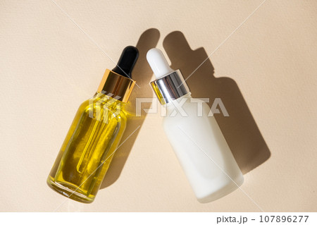 Natural cosmetics in glass jars with a pipette dispenser - oil and cream for skin and hair care Natural cosmetics in glass jars with a pipette dispenser - oil and cream for skin and hair care 107896277