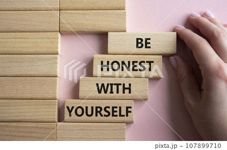 Be honest with Yourself symbol. Wooden blocks with words Be honest with Yourself. Businessman hand. Beautiful pink background. Be honest with Yourself concept. Copy space. 107899710
