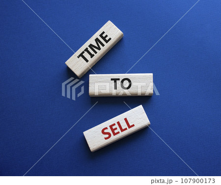 Time to Sell symbol. Concept words Time to Sell on wooden blocks. Beautiful deep blue background. Business and Time to Sell concept. Copy space. 107900173