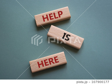 Help is here symbol. Wooden blocks with words Help is here. Beautiful grey green background. Business and Help is here concept. Copy space. Help is here symbol. Wooden blocks with words Help is here. Beautiful grey green background. Business and Help is here concept. Copy space. 107900177