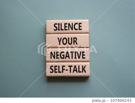 Silence your negative self-talk symbol. Concept words Silence your negative self-talk on wooden blocks. Beautiful grey green background. Psychology concept. Copy space. Silence your negative self-talk symbol. Concept words Silence your negative self-talk on wooden blocks. Beautiful grey green background. Psychology concept. Copy space. 107900243