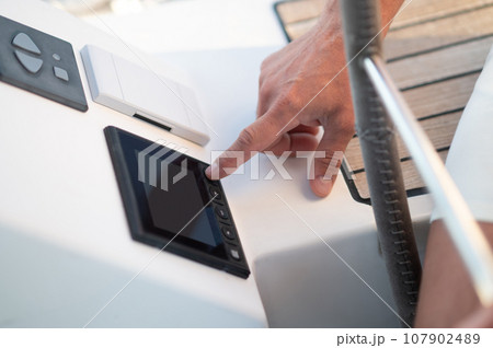 Close up of a mans hand pressing button on screen Close up of a mans hand pressing button on screen 107902489