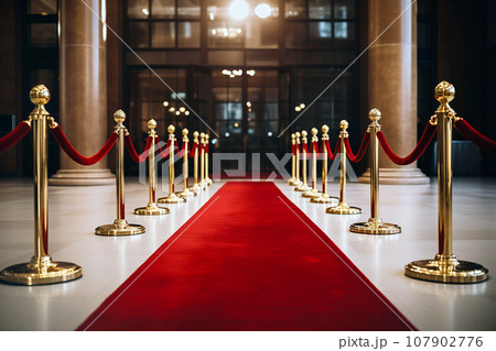 Red carpet with golden barriers and red ropes. Marking the route for celebrities, heads of state on ceremonial events, formal occasions. Red carpet entry, a way to success, VIP persons party entrance 107902776