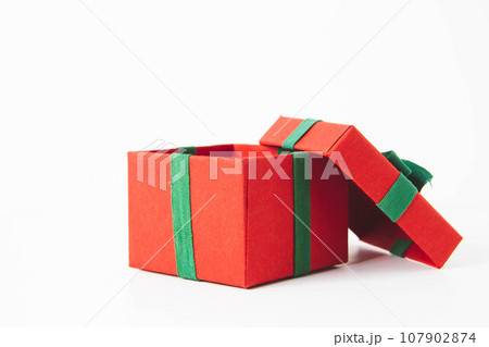 Present. Gift box with a bow. New Year's surprise. Red and green box with a gift 107902874