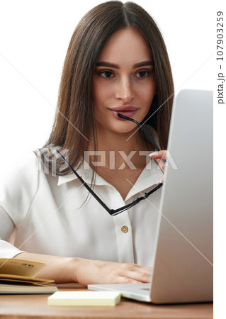 beautiful businesswoman using laptop computer for online work at table 107903259