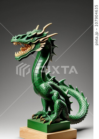 A statuette of a green wooden dragon. The dragon is the symbol of 2024. 107904635