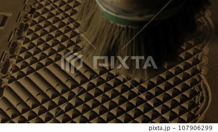 Close up of blowing away the dust from a wooden carved board with air flow. Creative. Industrial background, concept of carpentry. 107906299