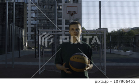 A handsome male athlete. Media. A man standing on a volleyball court with a ball. A handsome male athlete. Media. A man standing on a volleyball court with a ball. 107906455