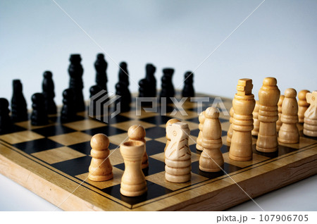 Battle between white and black chess on a chess boar. Strategy and tactics concept 107906705