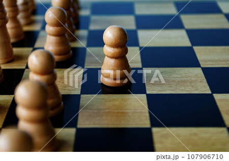 Selective view of wooden white pawn moving toward for battle. Strategy and tactic concept 107906710