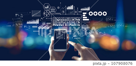 Micropayments theme with person using a smartphone at night 107908076