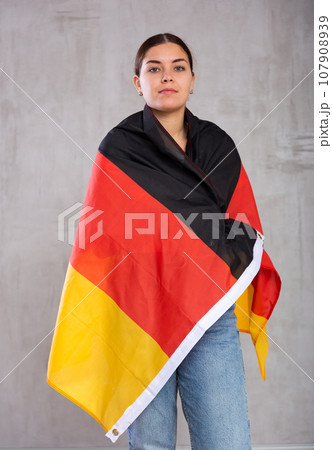 Focused woman holding Germany flag 107908939