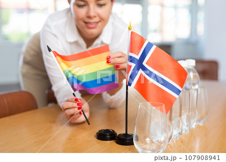 Unrecognizable girl sets midget Norway and Pride flag before international negotiations Unrecognizable girl sets midget Norway and Pride flag before international negotiations 107908941
