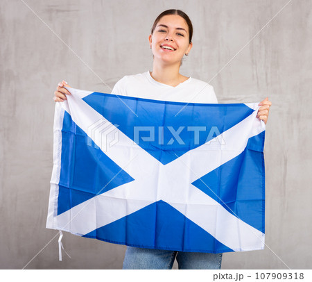 Positive young girl with Scotland flag rooting for your favorite team Positive young girl with Scotland flag rooting for your favorite team 107909318