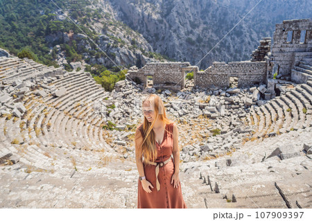 Woman tourist explores Stunning Ancient Theater of Termessos Ancient City turkiye, GO Everywhere Woman tourist explores Stunning Ancient Theater of Termessos Ancient City turkiye, GO Everywhere 107909397