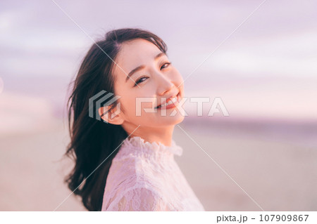 夕日バックの女性ポートレート 107909867