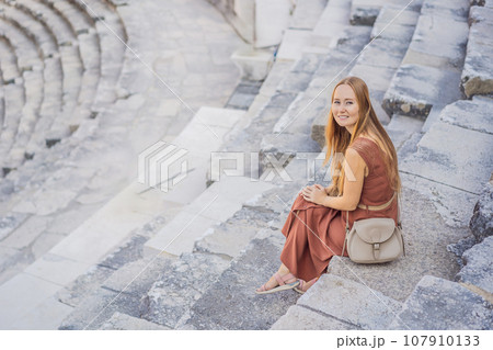 Woman tourist explores Aspendos Ancient City. Aspendos acropolis city ruins, cisterns, aqueducts and old temple. Aspendos Antalya Turkey. turkiye Woman tourist explores Aspendos Ancient City. Aspendos acropolis city ruins, cisterns, aqueducts and old temple. Aspendos Antalya Turkey. turkiye 107910133