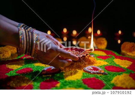 Clay diya lamps lit during diwali celebration, Diwali, or Deepavali, is India's biggest and most important holiday. Clay diya lamps lit during diwali celebration, Diwali, or Deepavali, is India's biggest and most important holiday. 107910192