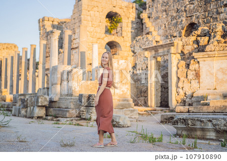Pretty tourist woman at the ruins of ancient city of Perge near Antalya Turkey Pretty tourist woman at the ruins of ancient city of Perge near Antalya Turkey 107910890