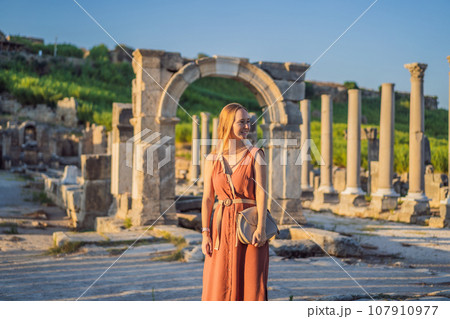 Pretty tourist woman at the ruins of ancient city of Perge near Antalya Turkey Pretty tourist woman at the ruins of ancient city of Perge near Antalya Turkey 107910977