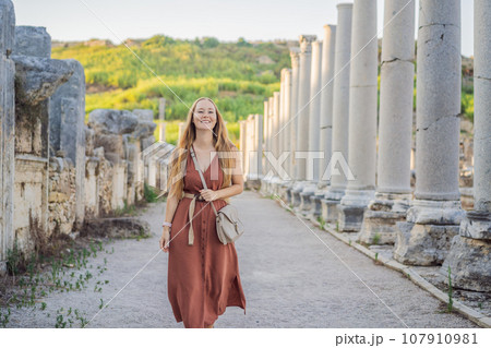 Pretty tourist woman at the ruins of ancient city of Perge near Antalya Turkey Pretty tourist woman at the ruins of ancient city of Perge near Antalya Turkey 107910981