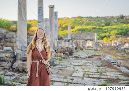 Pretty tourist woman at the ruins of ancient city of Perge near Antalya Turkey Pretty tourist woman at the ruins of ancient city of Perge near Antalya Turkey 107910983