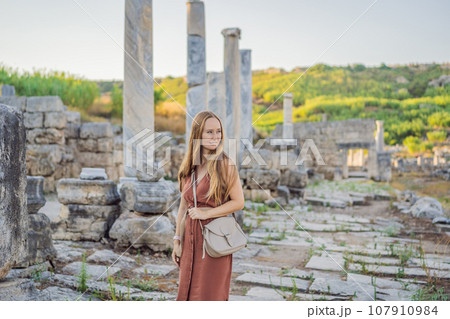 Pretty tourist woman at the ruins of ancient city of Perge near Antalya Turkey Pretty tourist woman at the ruins of ancient city of Perge near Antalya Turkey 107910984
