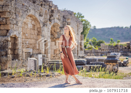 Pretty tourist woman at the ruins of ancient city of Perge near Antalya Turkey Pretty tourist woman at the ruins of ancient city of Perge near Antalya Turkey 107911718
