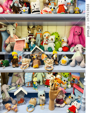 Multi-colored soft knitted toys on the shelves in the store Multi-colored soft knitted toys on the shelves in the store 107913688