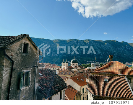 View over the ancient tiled roofs of houses on the domes of the church View over the ancient tiled roofs of houses on the domes of the church 107913972