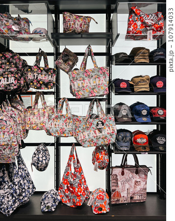 Multi-colored women bags and caps are on the shelves in the store. Caption: Italia Multi-colored women bags and caps are on the shelves in the store. Caption: Italia 107914033