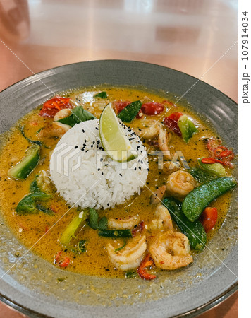 Shrimp curry lies on a plate on the table Shrimp curry lies on a plate on the table 107914034