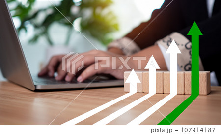 Businessman working showing graph with upward arrow for future growth plan of organization as business development concept for success and financial growth. Businessman working showing graph with upward arrow for future growth plan of organization as business development concept for success and financial growth. 107914187
