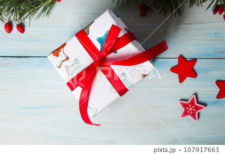 Decorated Christmas present on a table 107917663