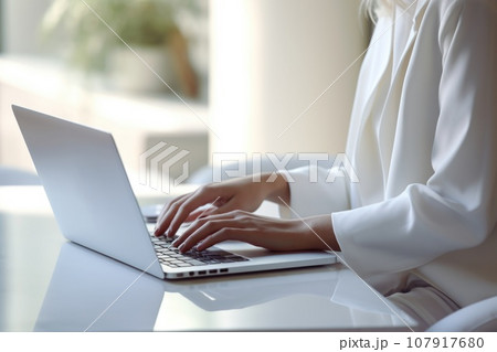 A woman is working at a laptop A woman is working at a laptop 107917680