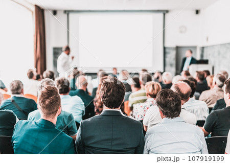 I have a question. Group of business people sitting at the chairs in conference hall. Businessman standing up asking a question. Conference and Presentation. Business and Entrepreneurship. I have a question. Group of business people sitting at the chairs in conference hall. Businessman standing up asking a question. Conference and Presentation. Business and Entrepreneurship. 107919199